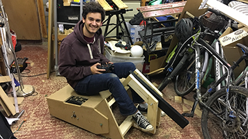 Tom sitting on the wooden prototype